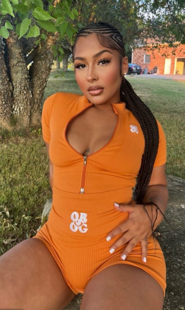 Model wearing the orange OBIOG Zulu Sunset two-piece set